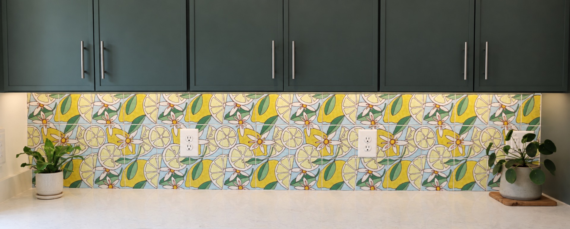 Emily’s hand-painted lemon blossom tile in a finished kitchen backsplash